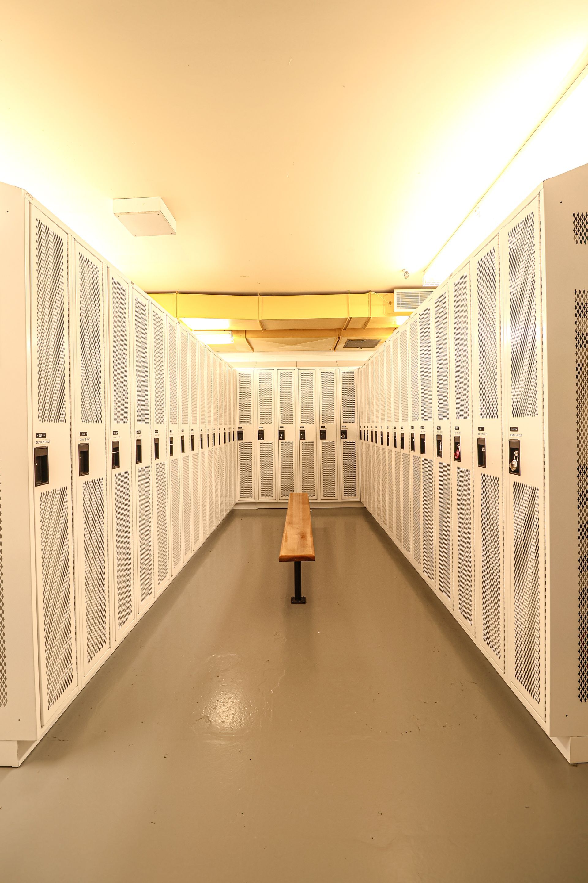 There is a bench in the middle of the locker room.