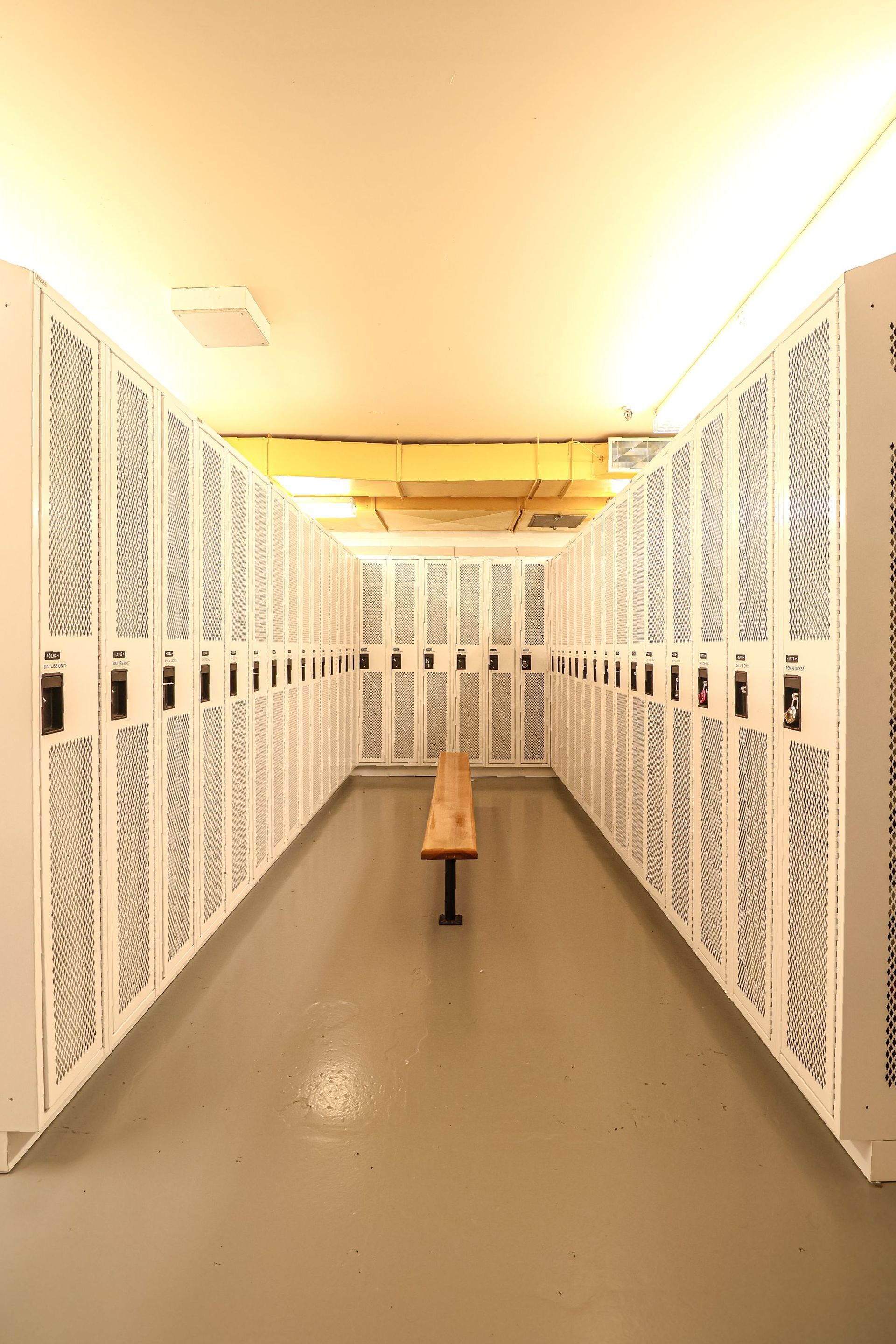 There is a bench in the middle of the locker room.