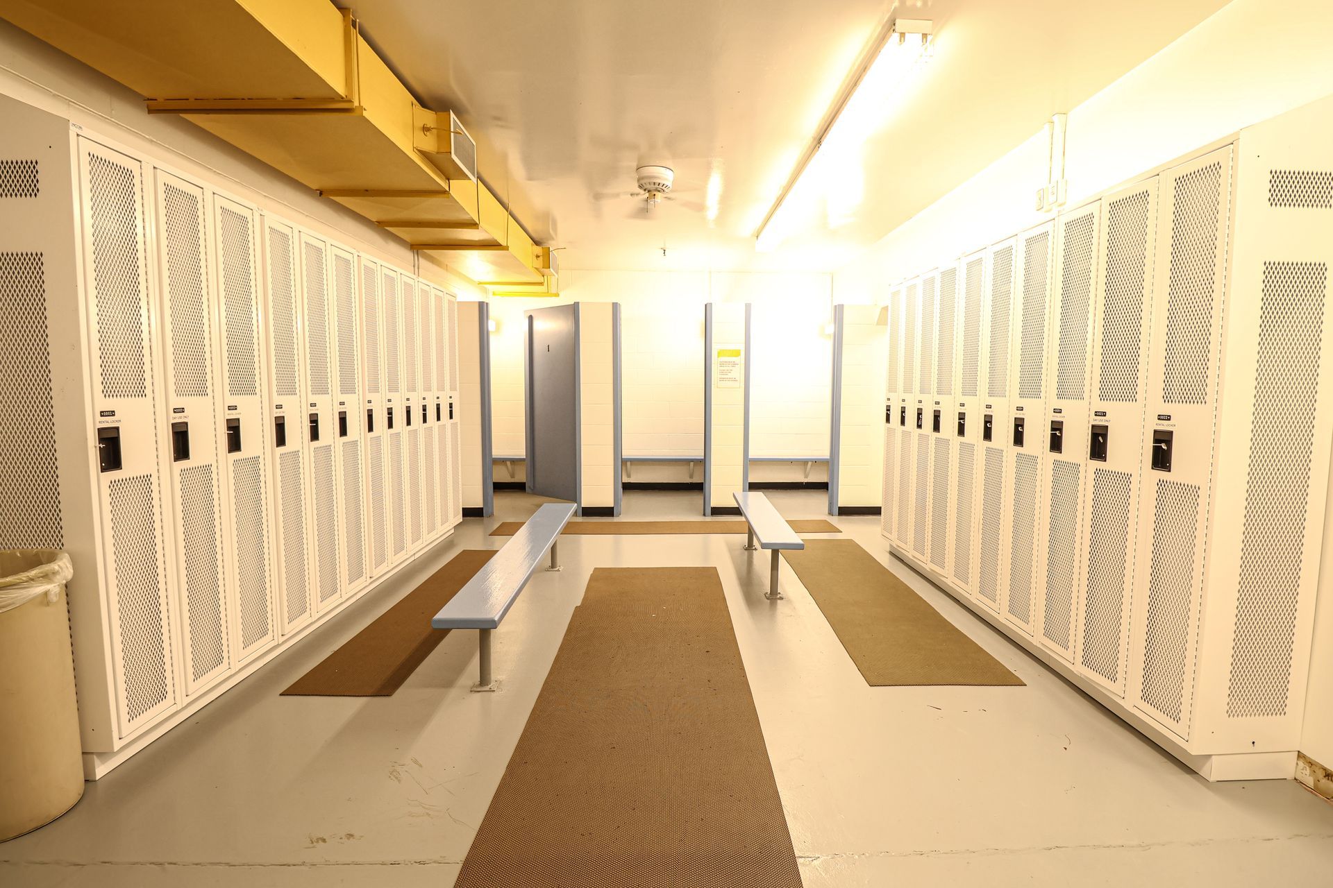 A locker room with lots of lockers and benches