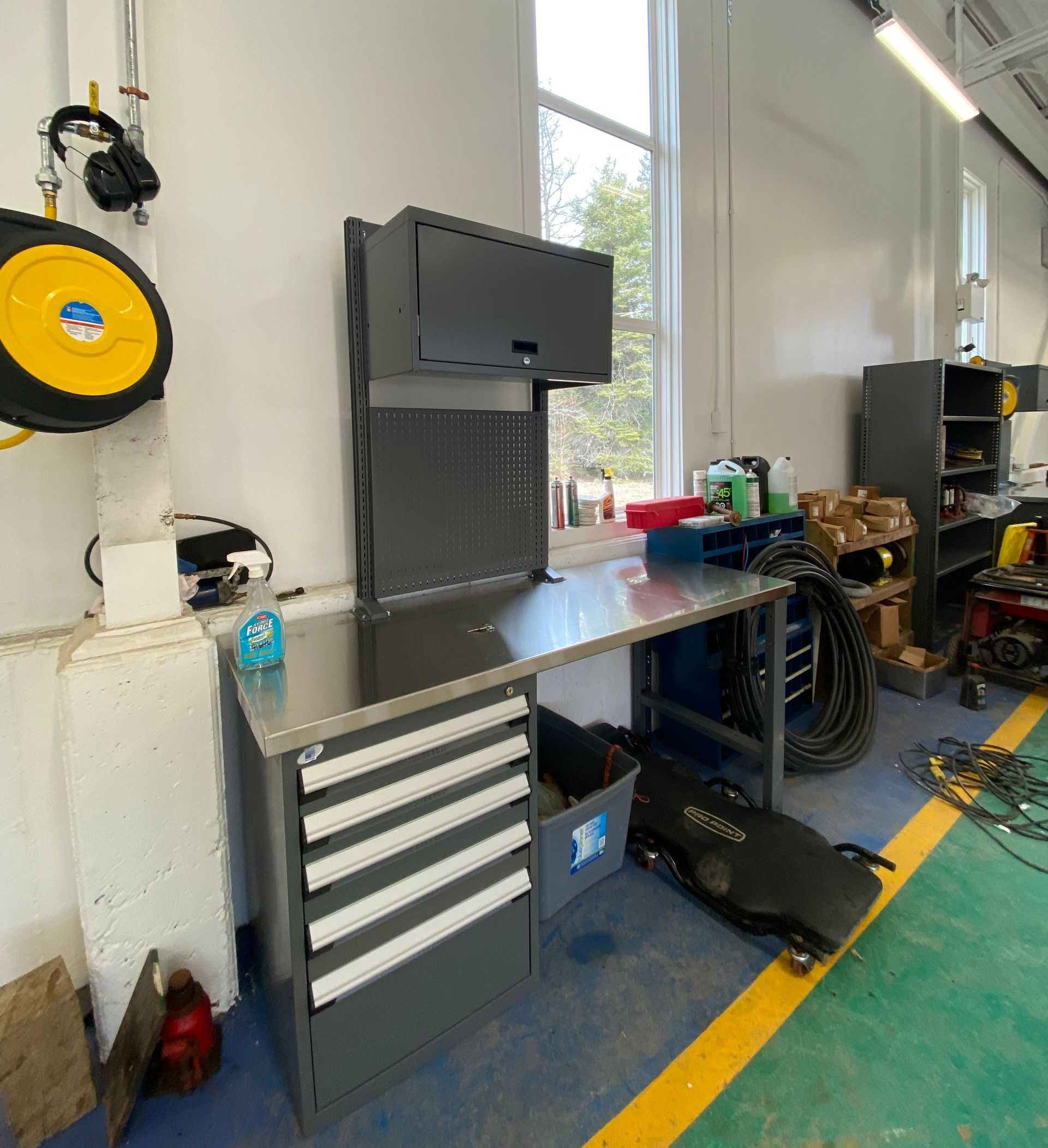 A workbench in a garage with a yellow line on the floor.