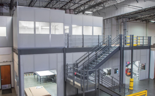 A large warehouse with stairs leading up to the second floor.
