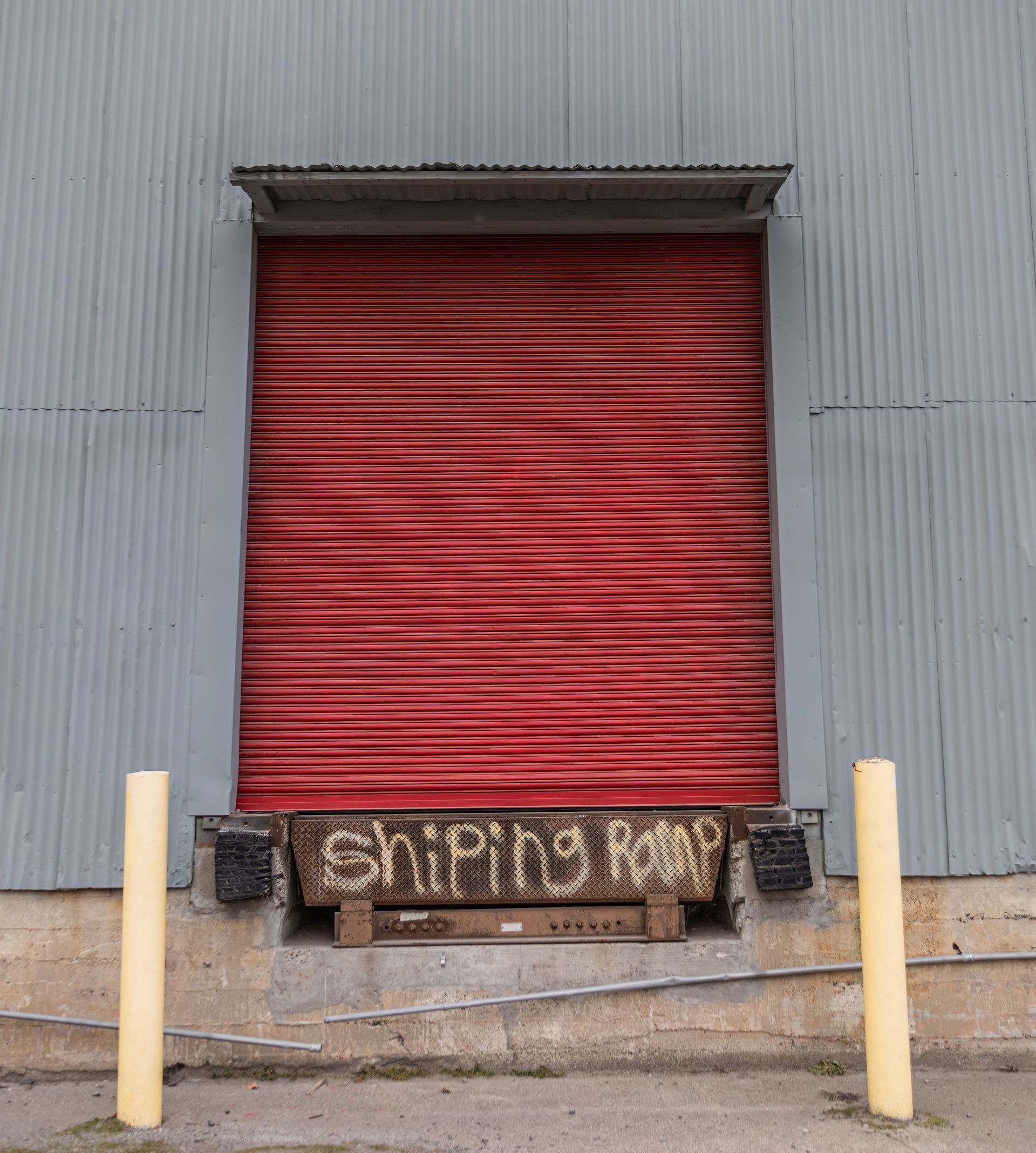 An orange door with a green exit sign above it