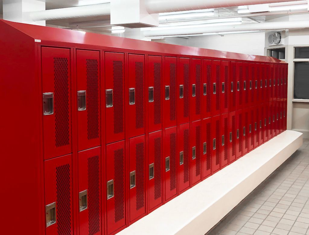 Row of bright red school lockers in a clean hallway