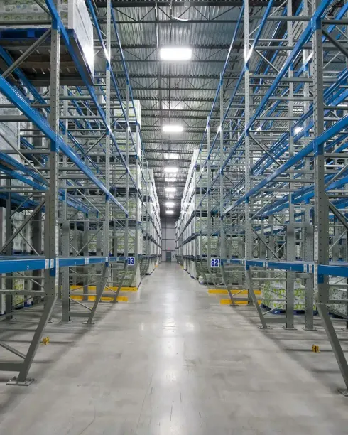 A large warehouse filled with lots of shelves and pallets.