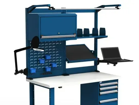 A workbench with a laptop and a lamp on it.