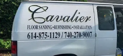 White van with “Cavalier” flooring, refinishing and installations sign and phone numbers on the side.