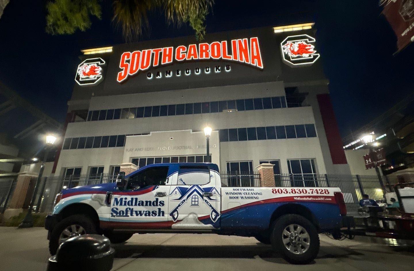 A truck is parked in front of a building that says south carolina