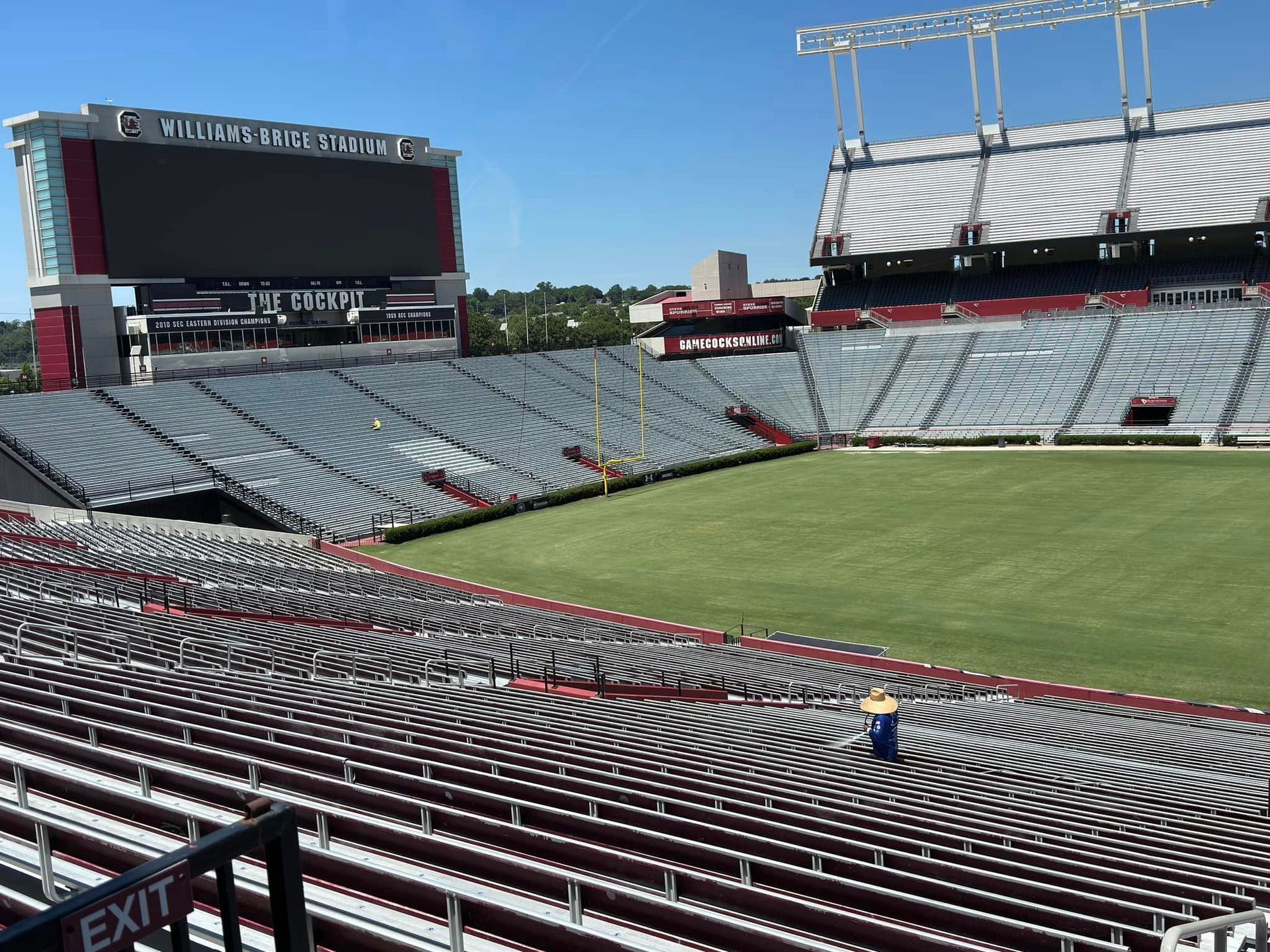 An empty stadium with the word exit on the railing