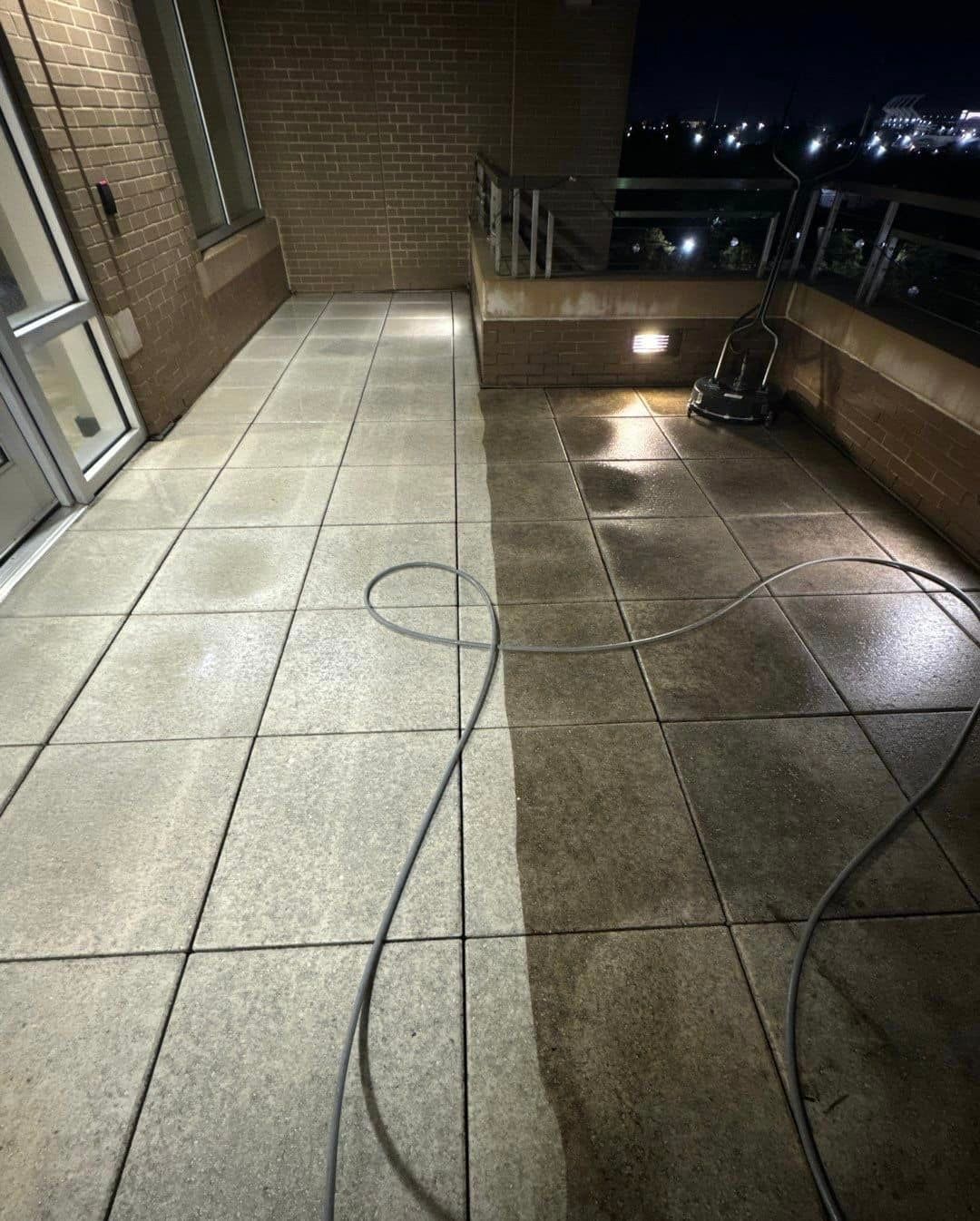 A tiled floor is being cleaned with a vacuum cleaner.