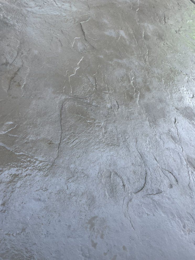 Close-up of a rough gray concrete surface with subtle cracks and texture