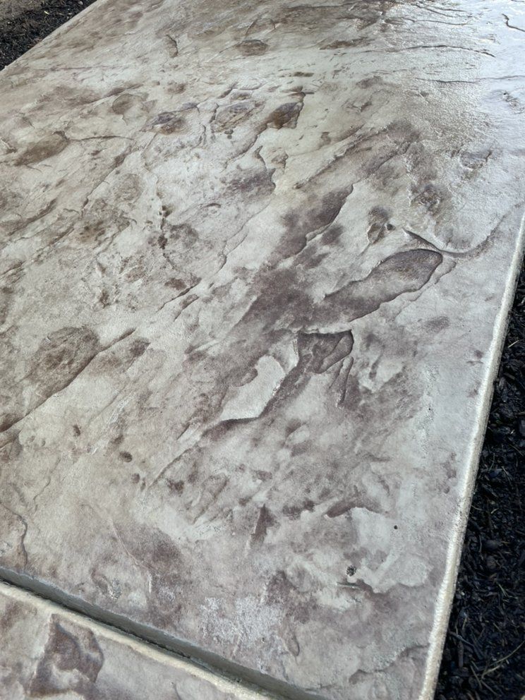 Marbled stone tabletop with gray and white veining, viewed at an angle.