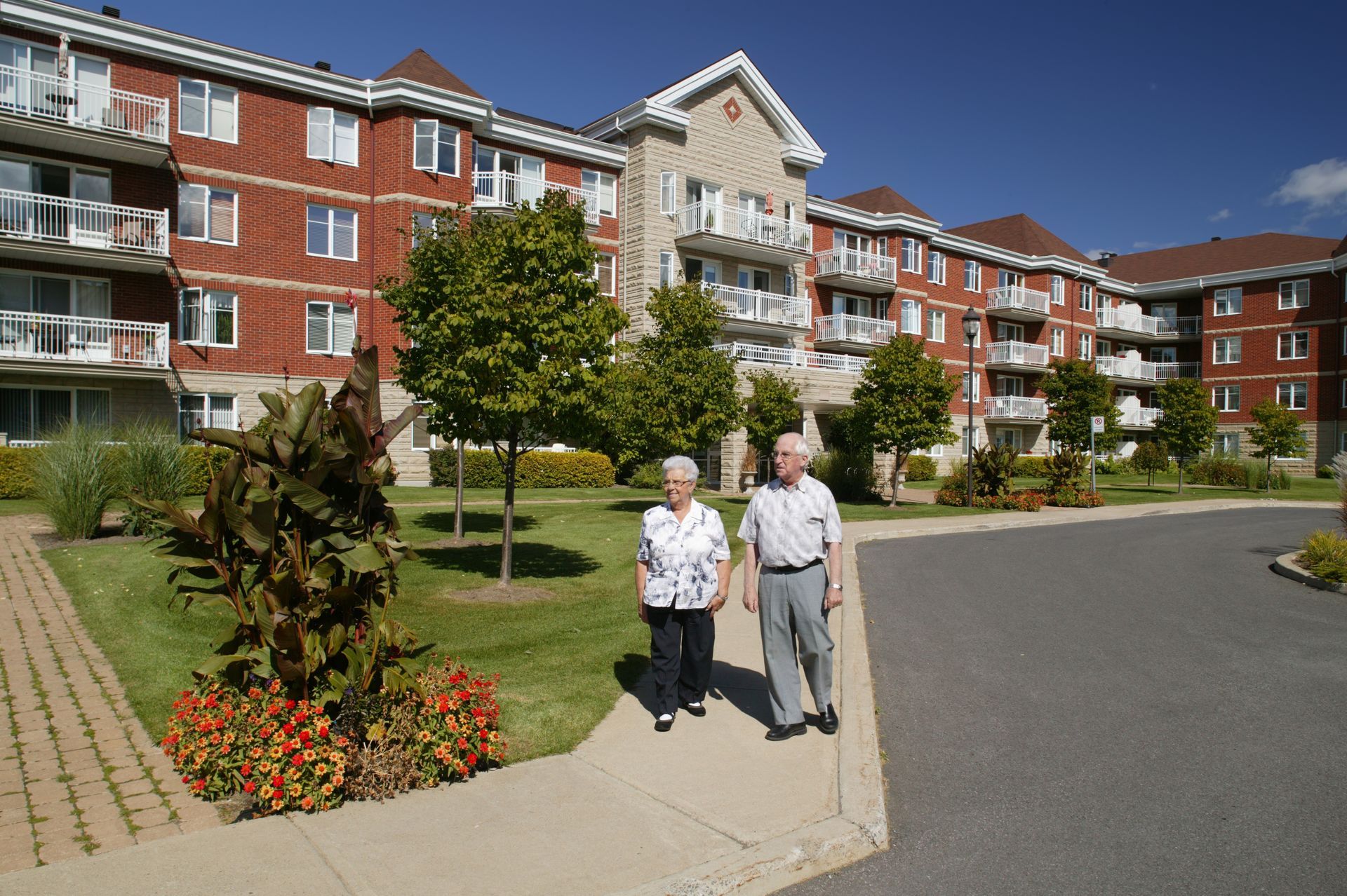 Senior couple happily enjoying a peaceful walk outdoors on a sunny day.