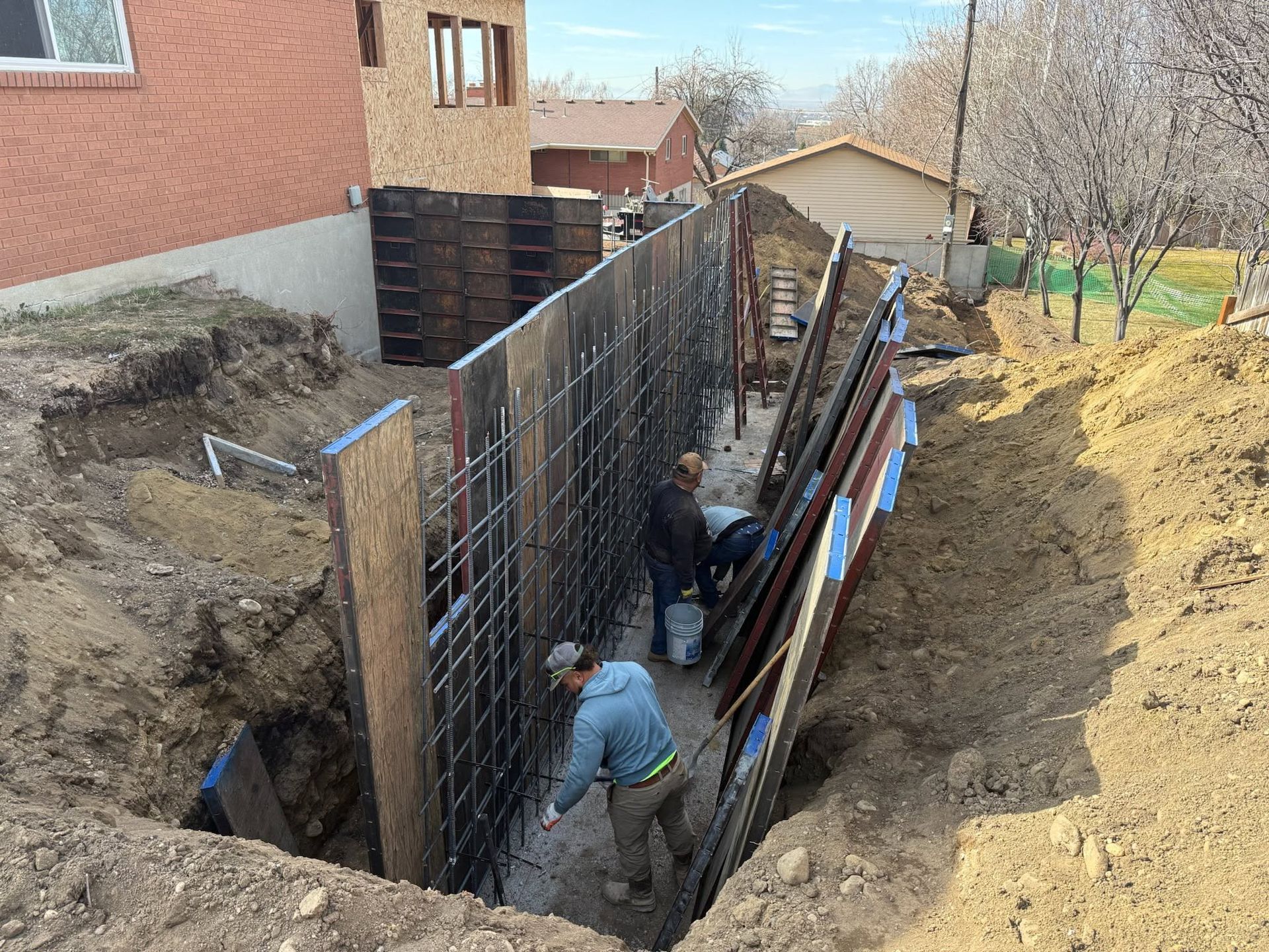 A concrete foundation is being built in a residential area.
