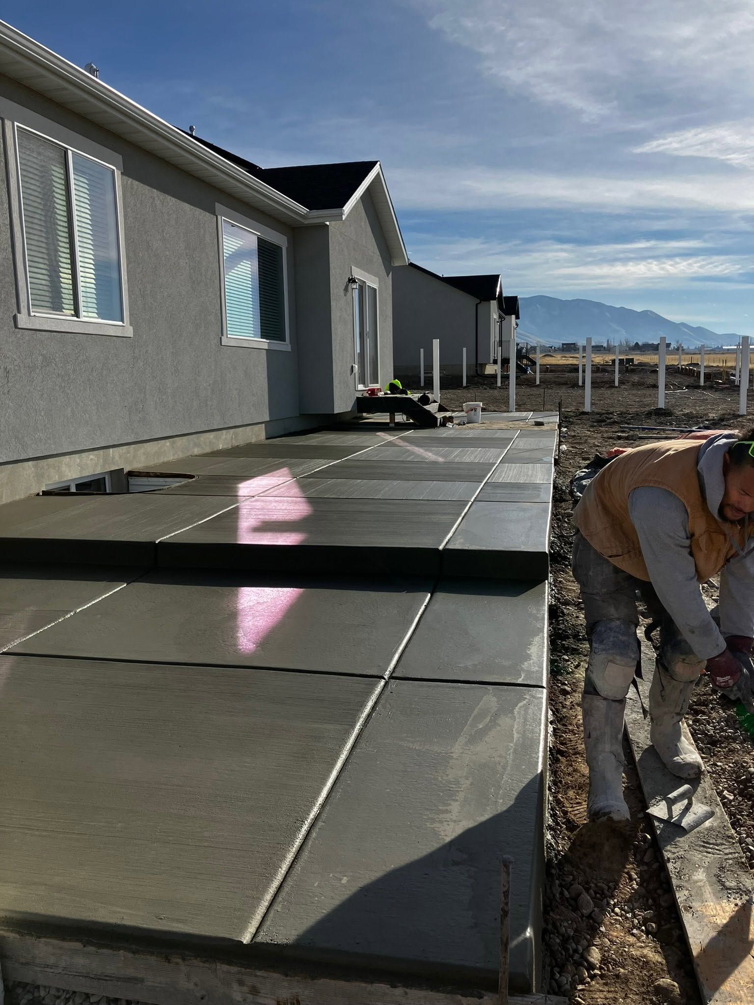 A concrete foundation is being built in a residential area.