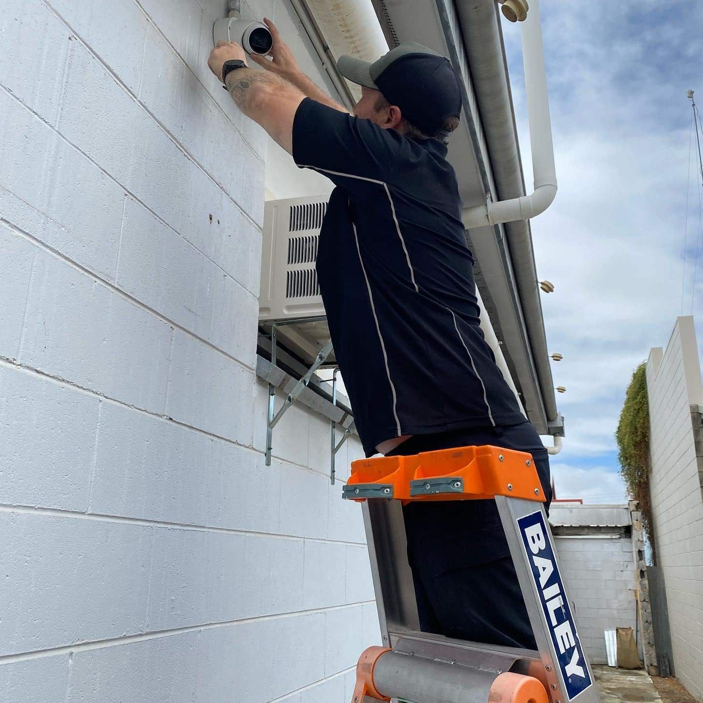 A Bailey Ladder is Being Used by a Man — DGC Tech Solutions In Mareeba, QLD