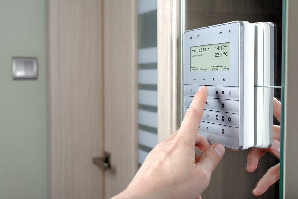 A Person is Pressing a Button on a Security System — DGC Tech Solutions In Mareeba, QLD
