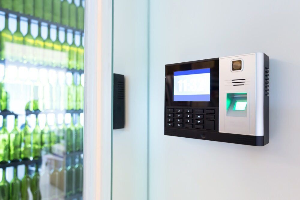 A Fingerprint Scanner is Hanging on a Wall Next to a Vending Machine — DGC Tech Solutions In Mareeba, QLD