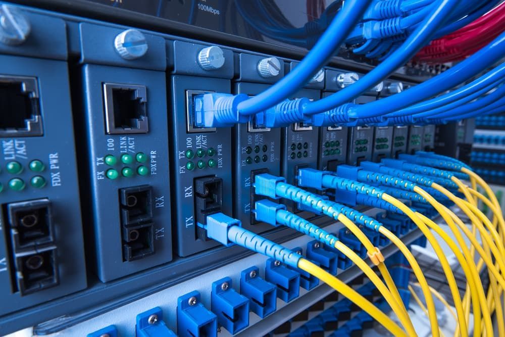 A Bunch of Blue and Yellow Wires Are Connected to a Server — DGC Tech Solutions In Mareeba, QLD
