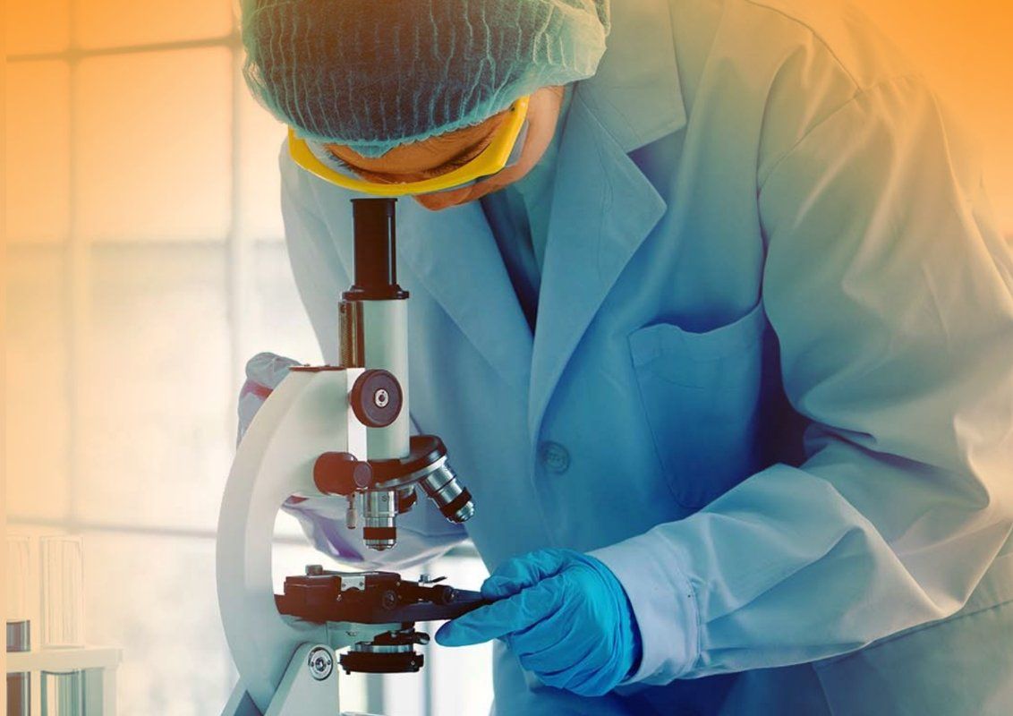 A scientist is working with a microscope