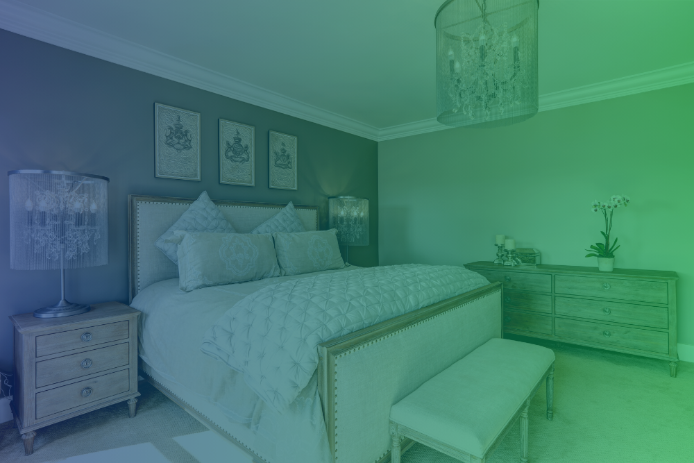 A bedroom with a large bed and a picture on the wall above it.