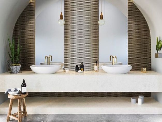Bathroom with double sinks, arched mirrors, brass fixtures, and neutral tones.