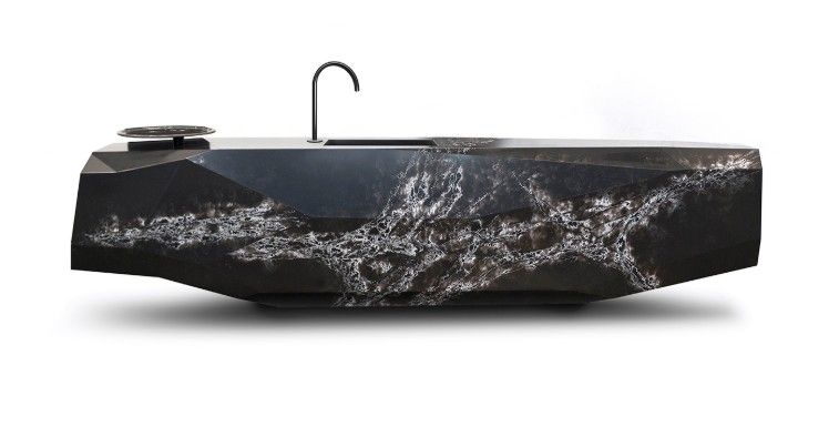 Black stone bathroom sink with chrome faucet. Rough, textured exterior; white background.