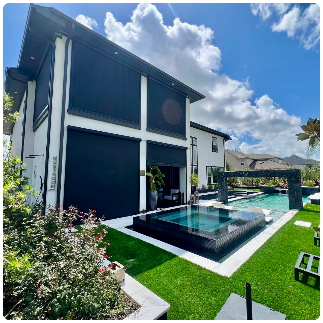 A large white house with a swimming pool in the backyard.