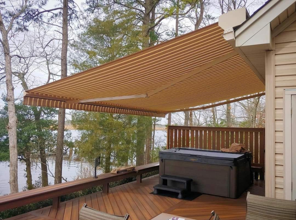 A hot tub on a deck with a motorized awning in texas