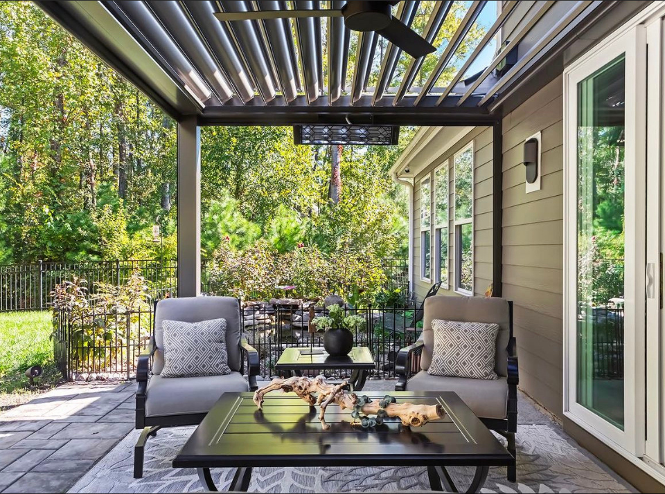 There is a large swimming pool in the backyard of a house with a modular pergola in texas