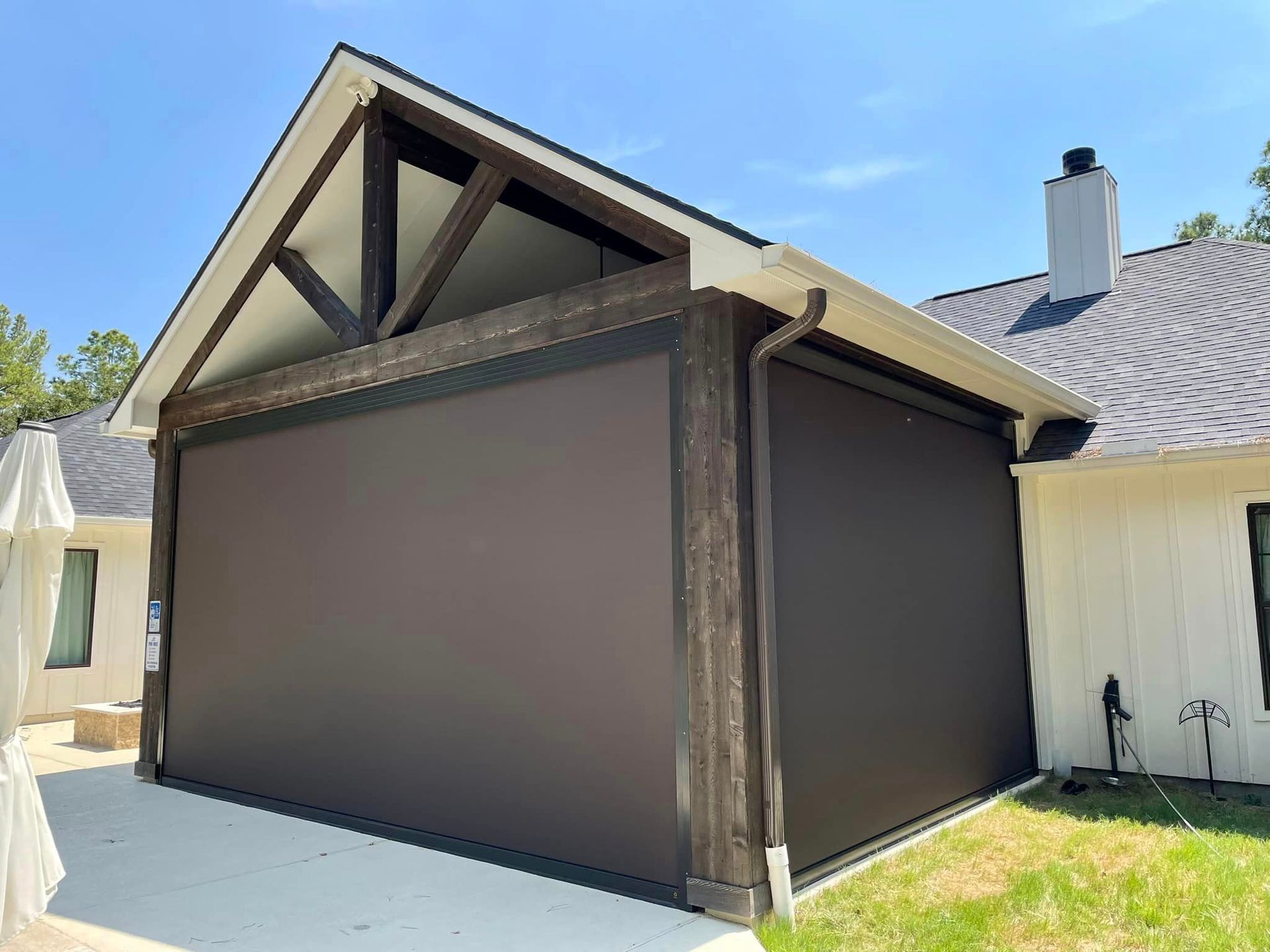 A house with a large screen on the side of it.