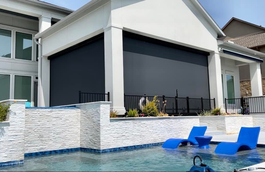 A large white house with a swimming pool in front of it.