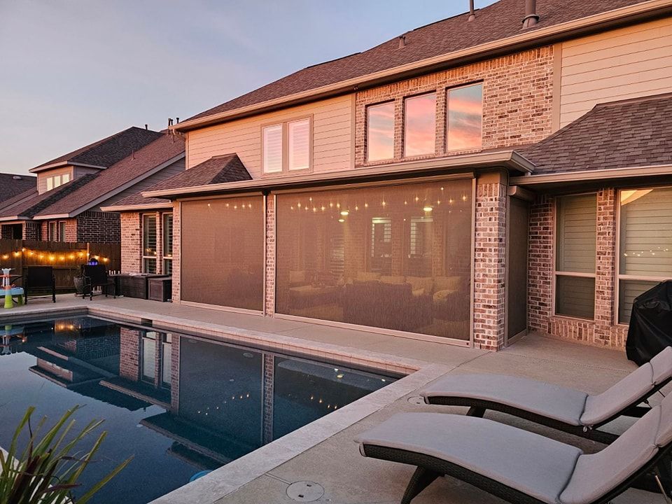 A large house with a swimming pool in front of it.