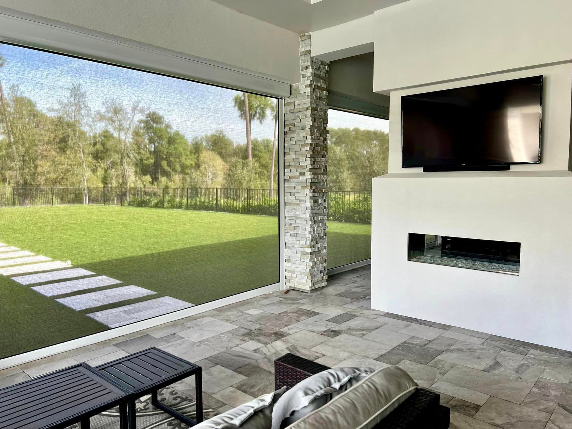 A living room with a couch and a flat screen tv