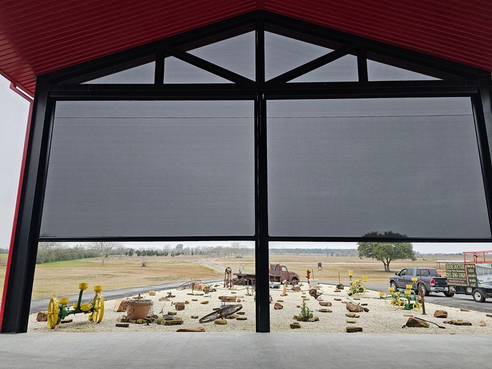 A large window with a view of a field.