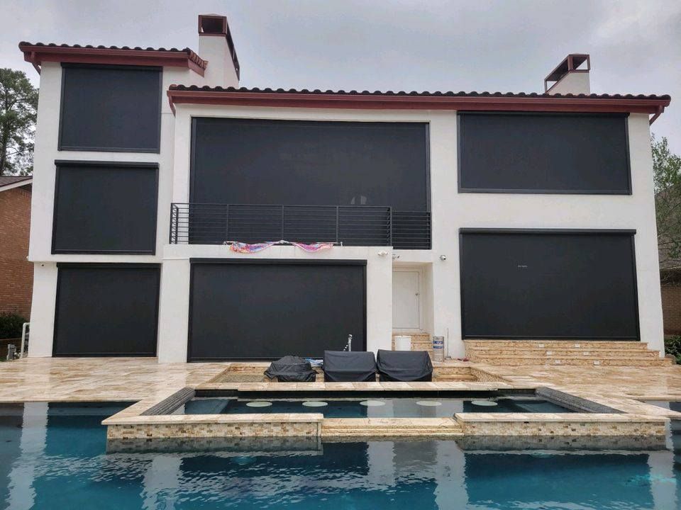 A large house with a swimming pool in front of it