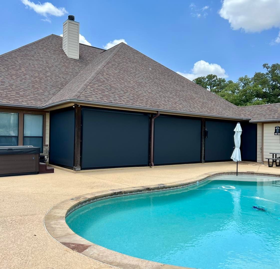 A house with a swimming pool in front of it