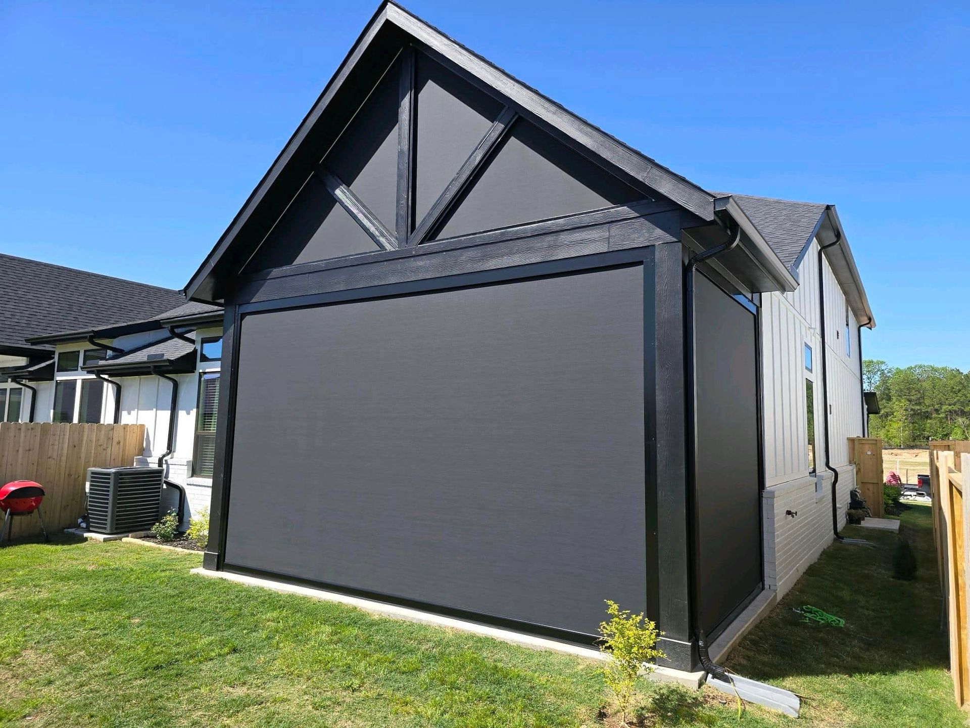 A house with a screen on the side of it.