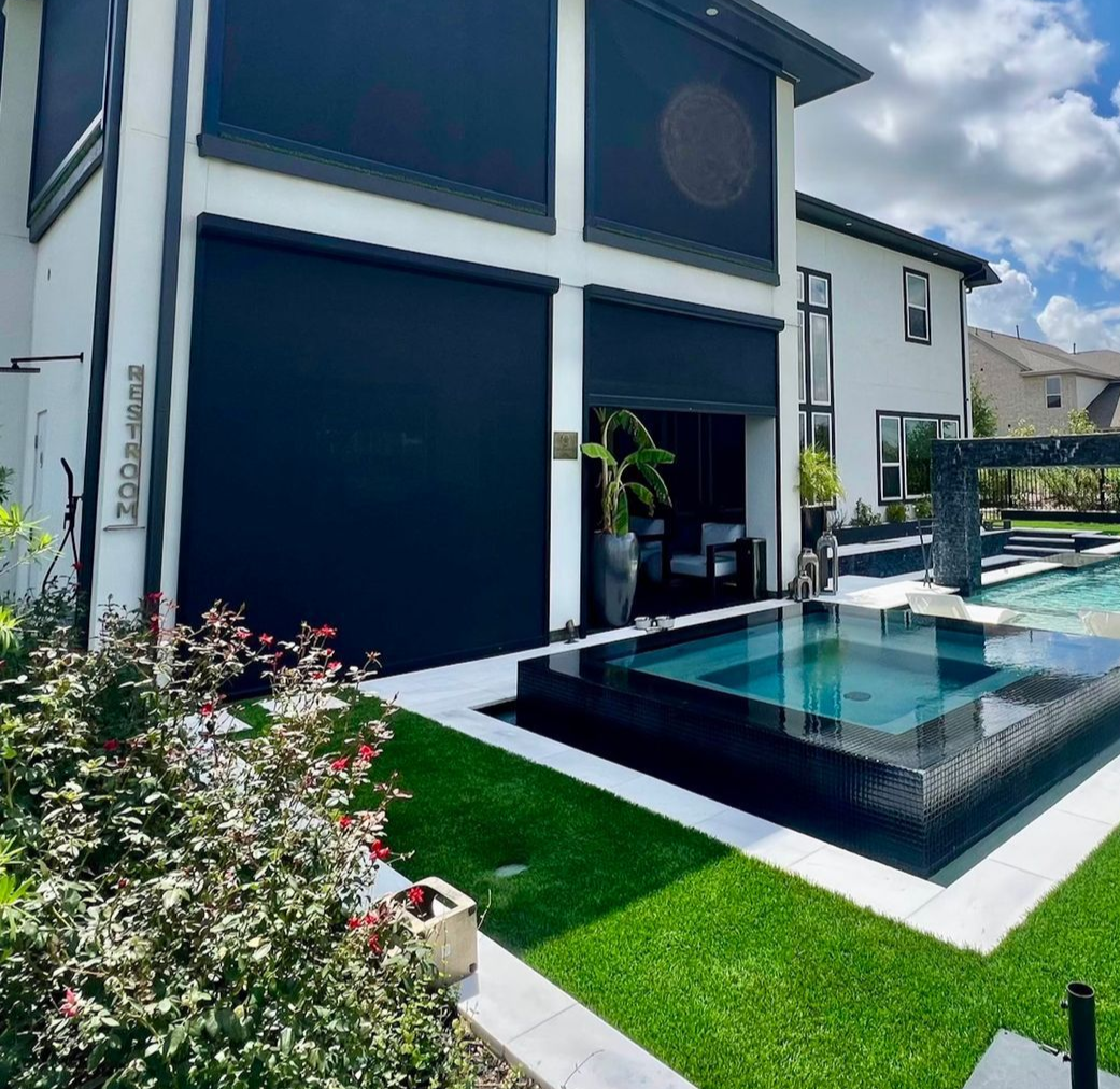 A large swimming pool with a pergola in the backyard of a house.