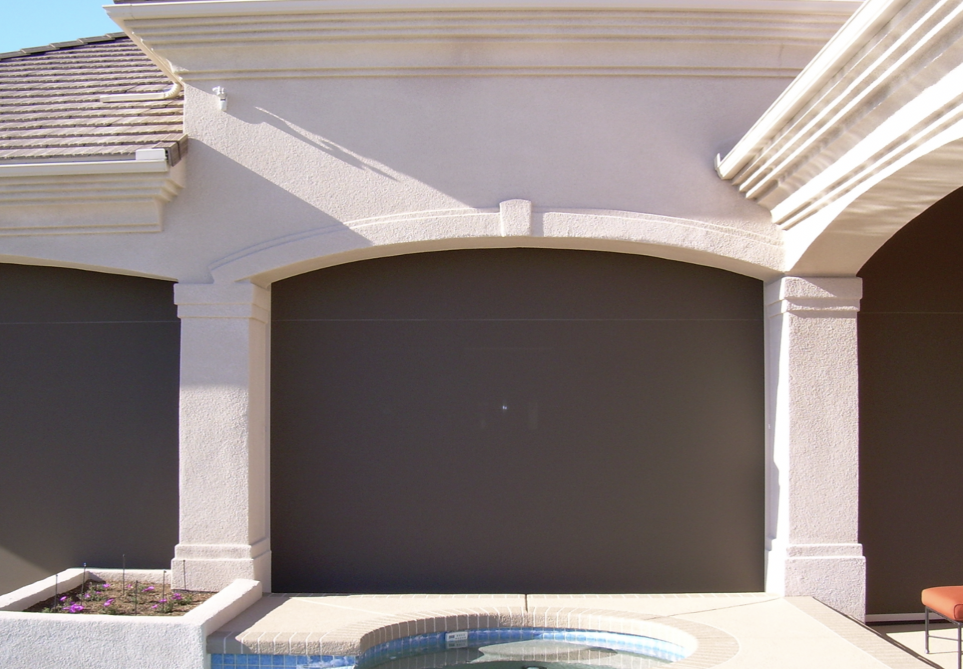 A house with a swimming pool in front of it