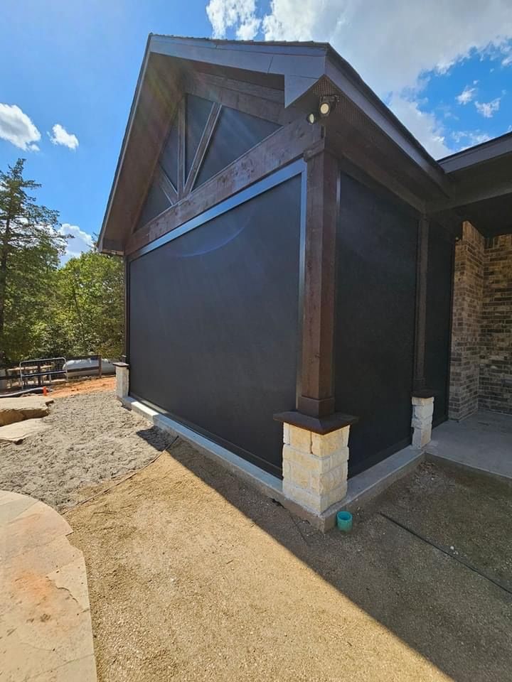 A house with a large black screen on the side of it.
