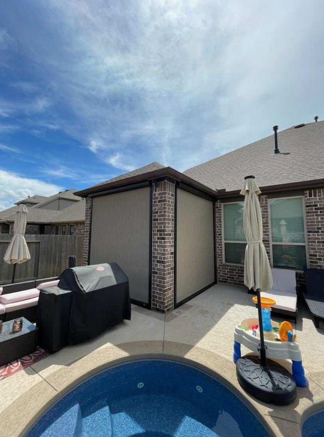 There is a swimming pool in the backyard of a house.