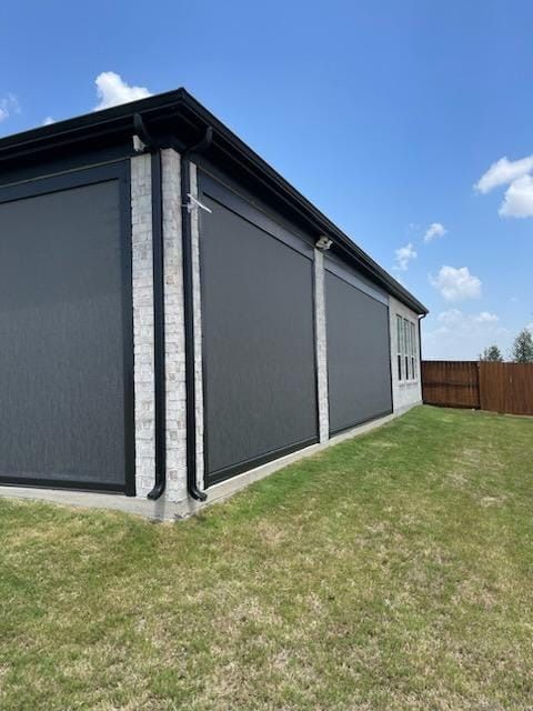 A house with a lot of windows and screens on the side of it.