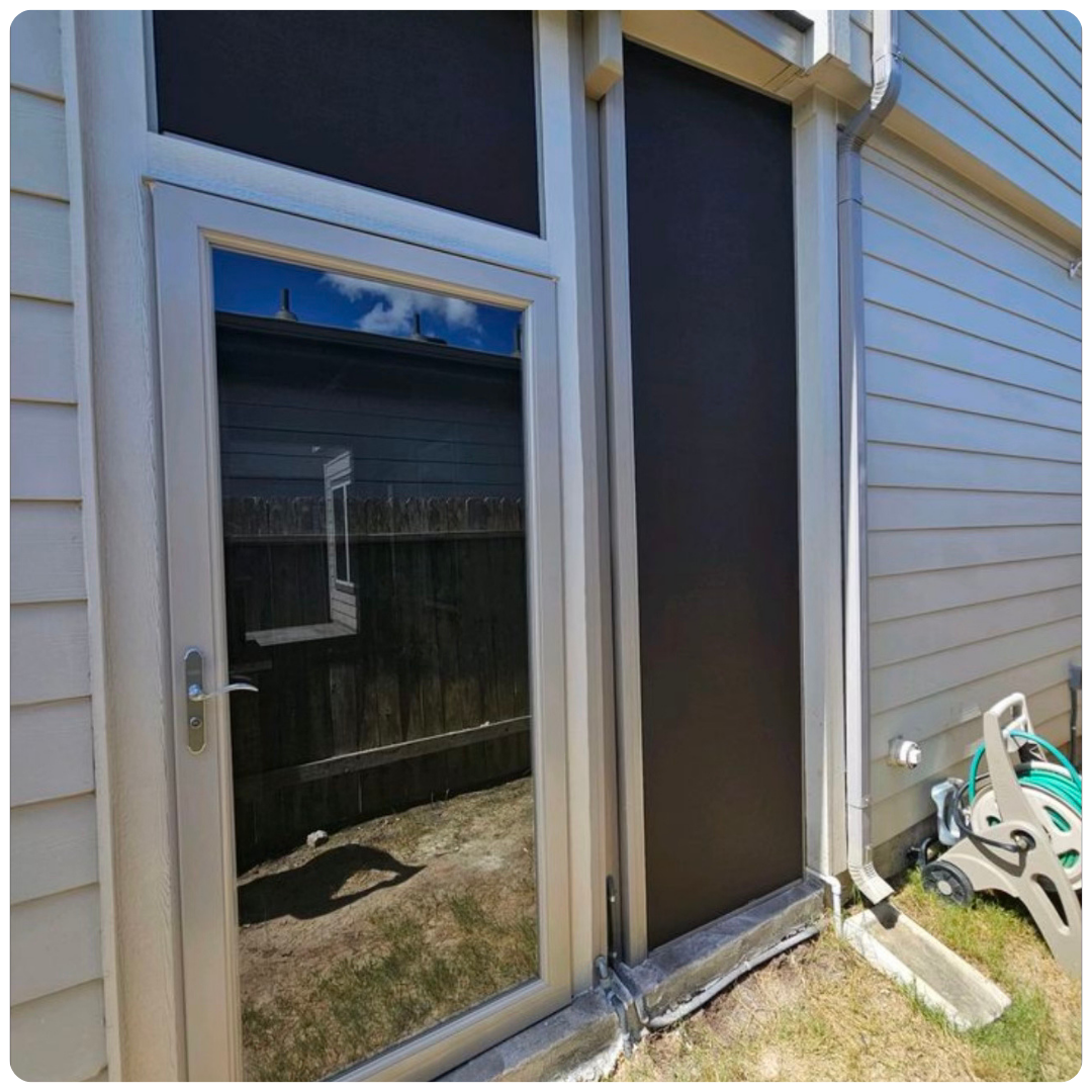 A custom storm doors texas is on the side of a house.