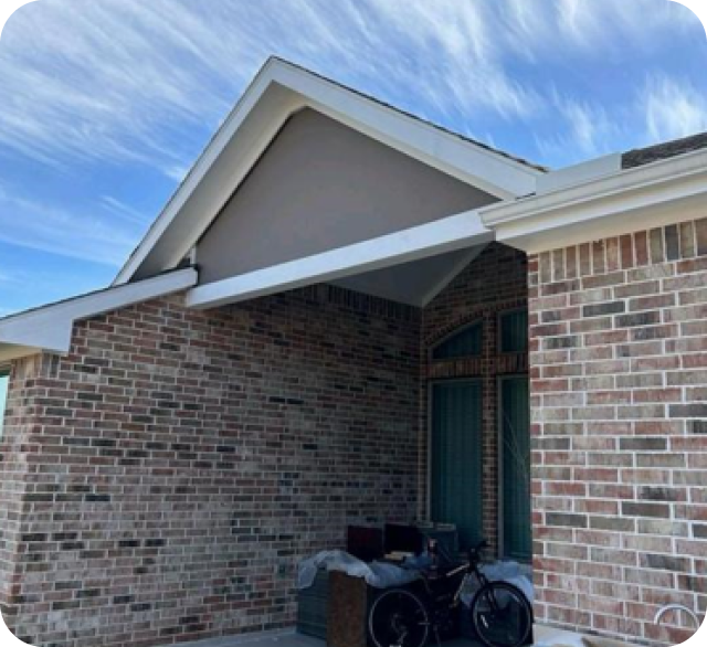 A brick house with a Beam Buildout for custom for shade installation in texas