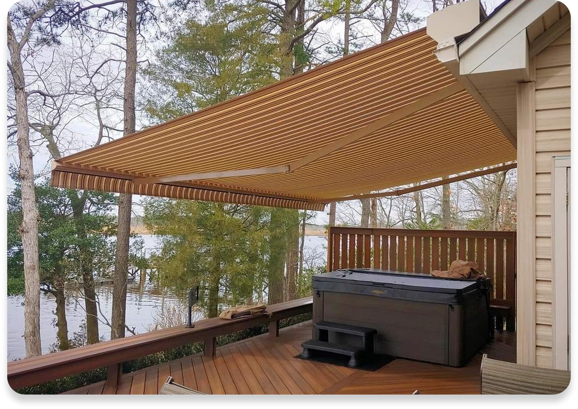 A hot tub on a deck with an awning over it