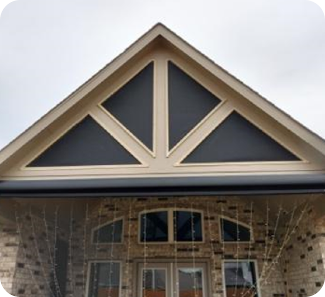 A brick house with a triangle fixed custom shades texas