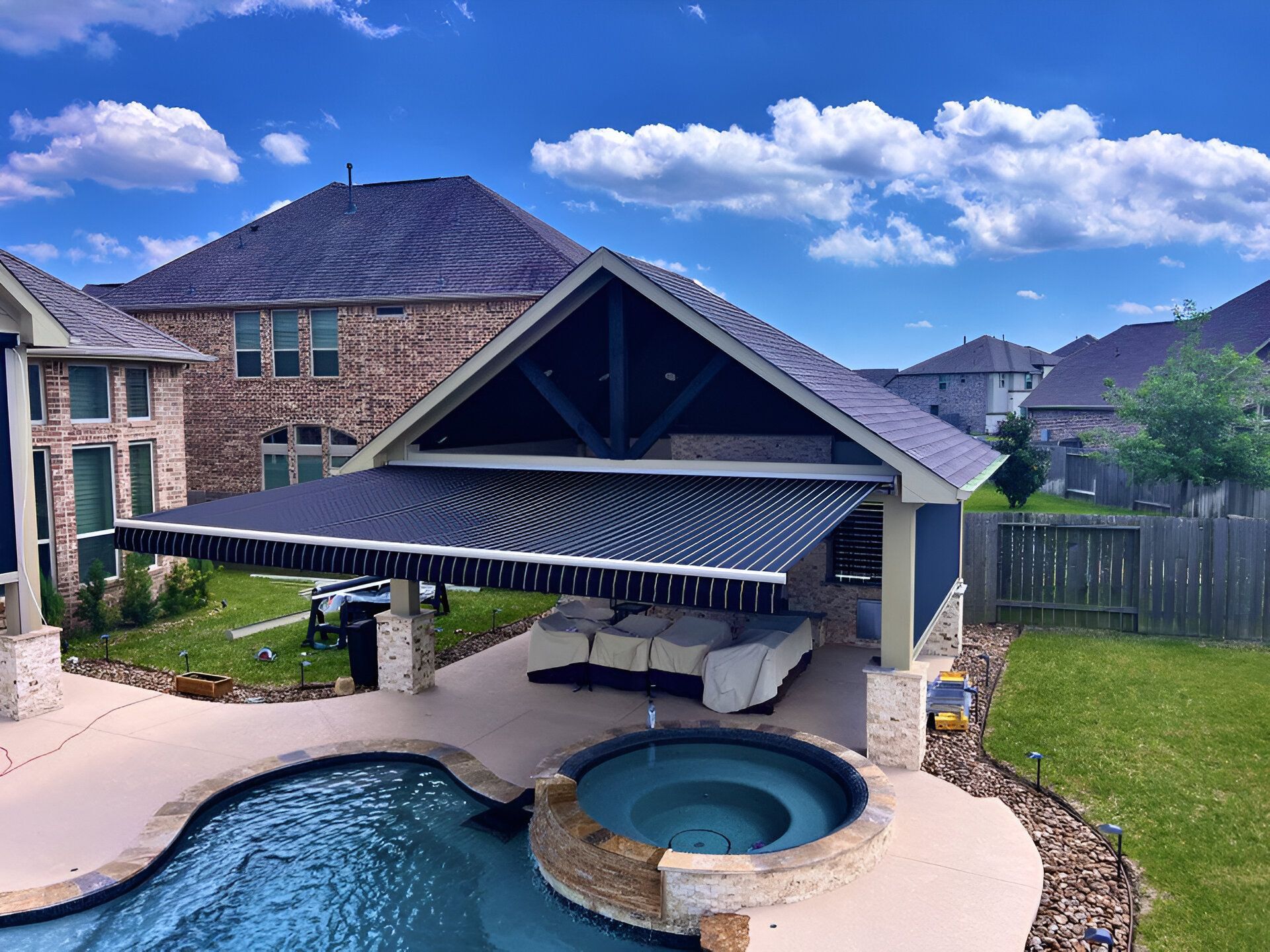A house with a swimming pool and a hot tub in front of it.