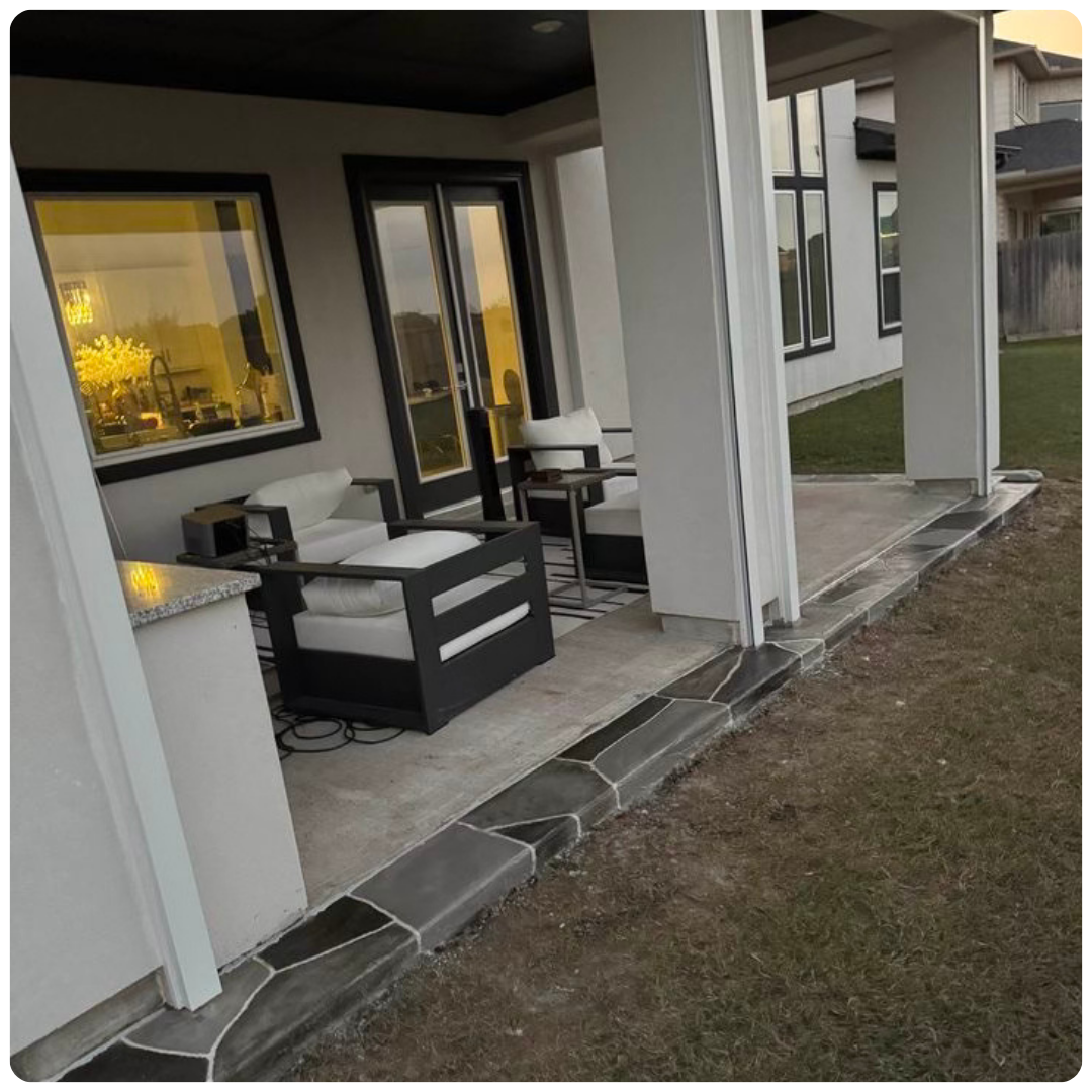 A porch with chairs and custom outdoor shades in front of a house.