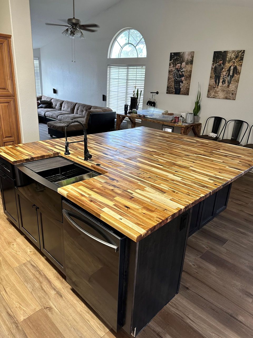 A kitchen with a large island and a sink.