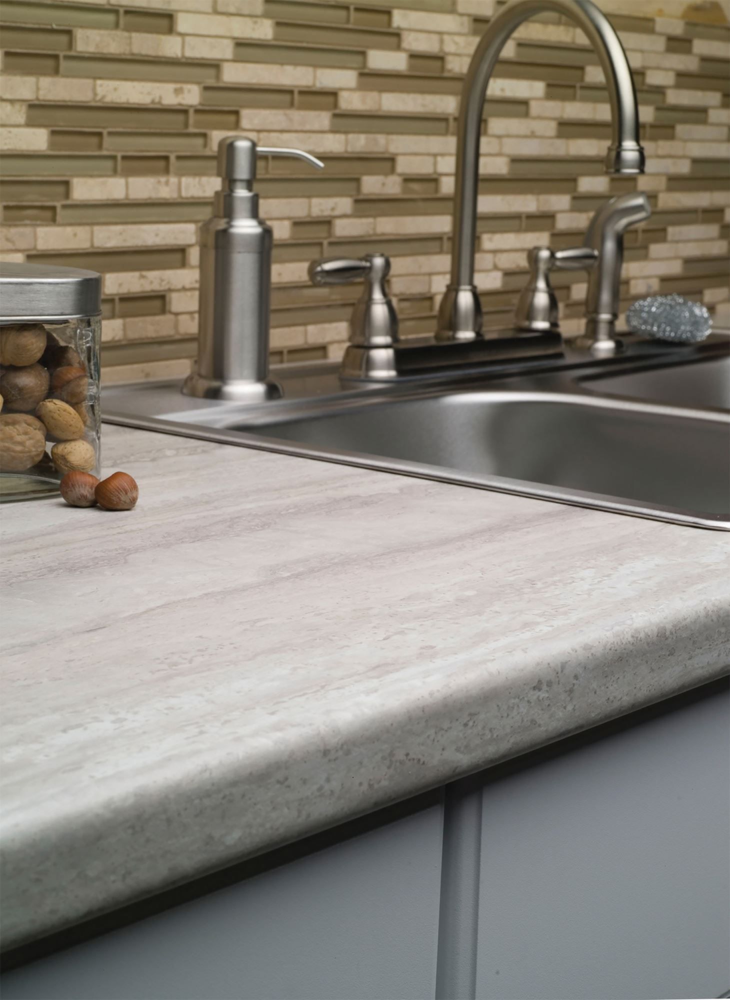 A kitchen with white cabinets, wooden counter tops, and a sink.
